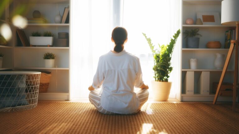 Calm woman meditating at home – supporting emotional balance and mental clarity through medicinal mushroom treatments