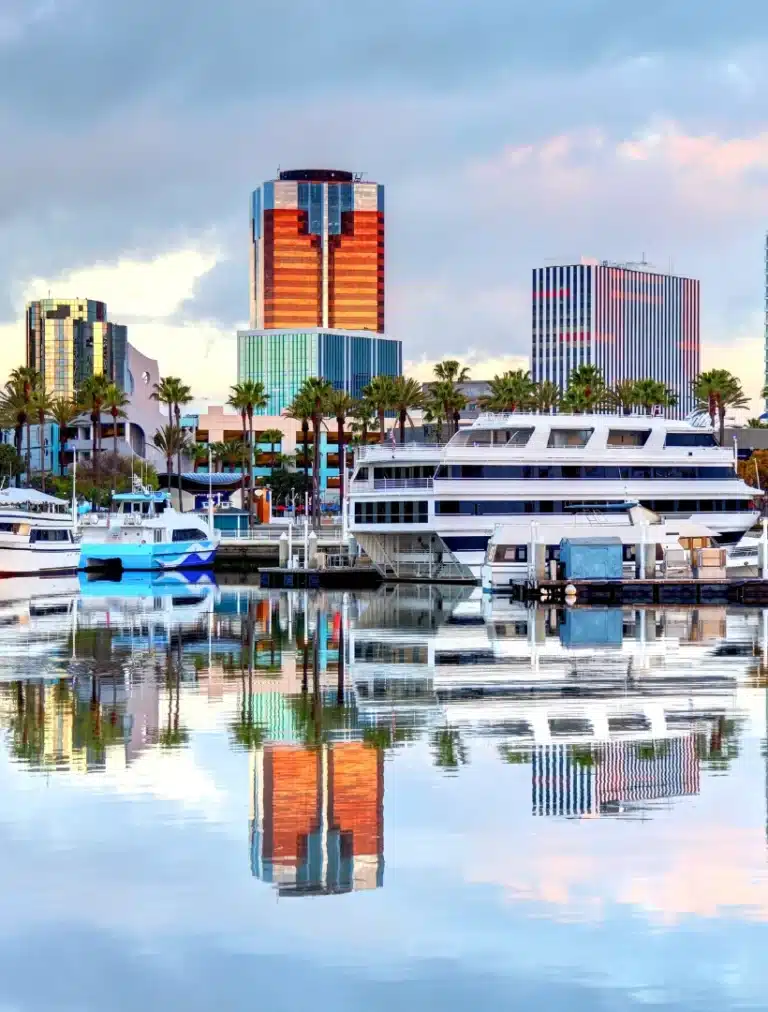 A peaceful view of Long Beach, California, featuring coastal cityscapes, palm trees, and calm ocean surroundings that reflect a relaxed Southern California atmosphere.
