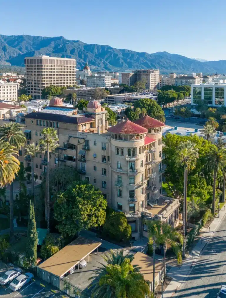 A scenic view of Pasadena, California, showing tree-lined streets, historic architecture, and mountain backdrops that capture the city’s calm and refined atmosphere.